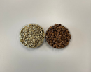 Two bowls of coffee beans, one green and one roasted, on a white background